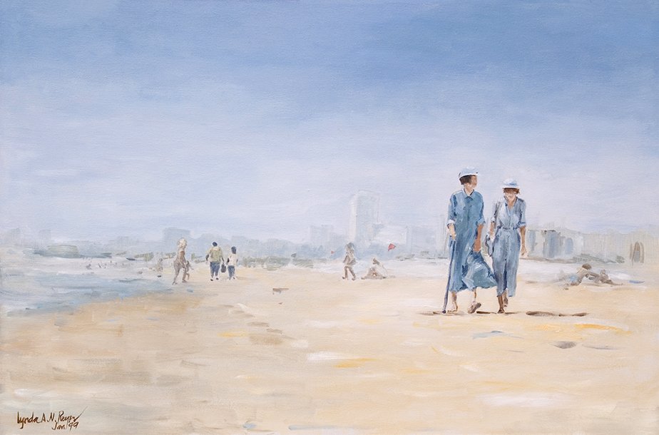 two women walking on the beach wearing denim dresses