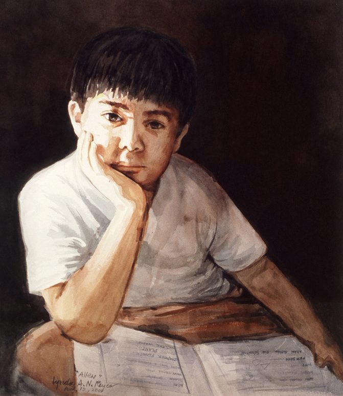 portrait of young boy with an open book on his lap gazing at viewer
