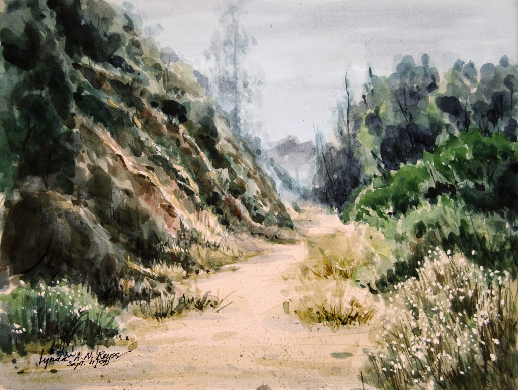 watercolor painting of a pathway between a rock face and trees